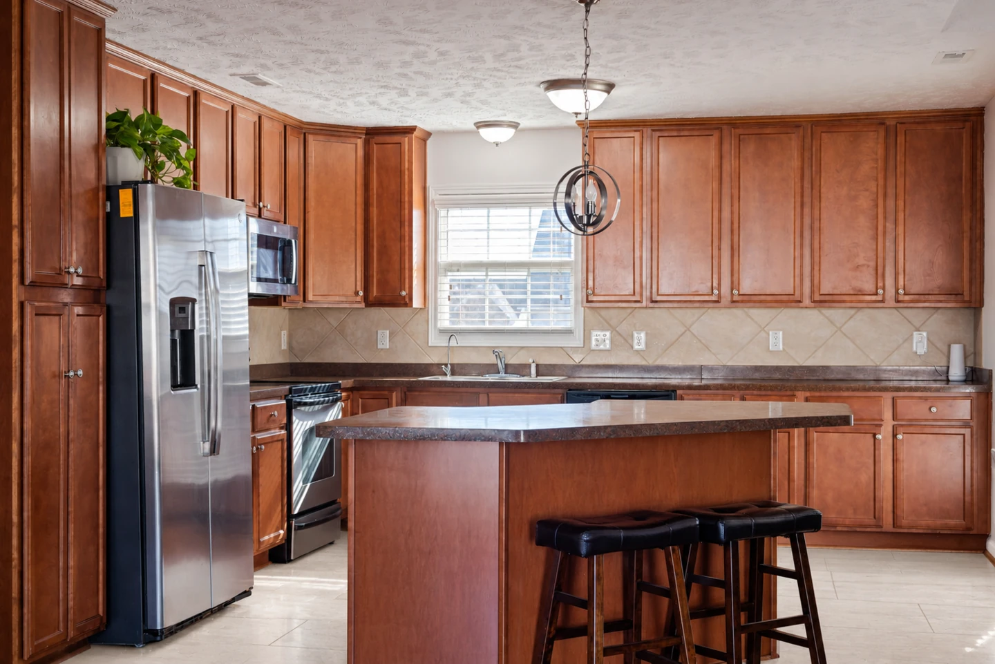 AI limestone floor concept in the same kitchen with the original island, stools and cabinetry