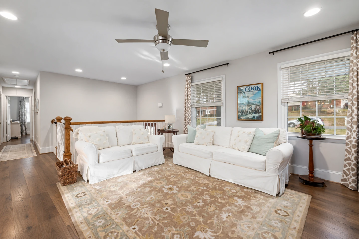 AI walnut floor preview around the original white sofas and patterned rug