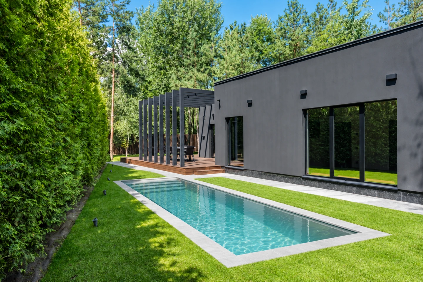 AI rectangular pool concept in a narrow garden beside the original gray facade and hedge