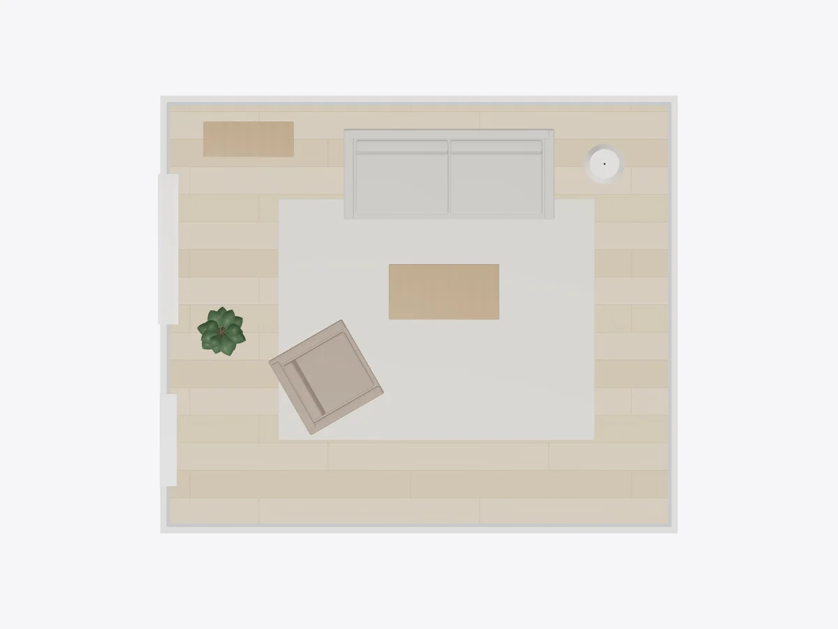 Overhead view of the sample living room with a sofa, rug, coffee table and armchair