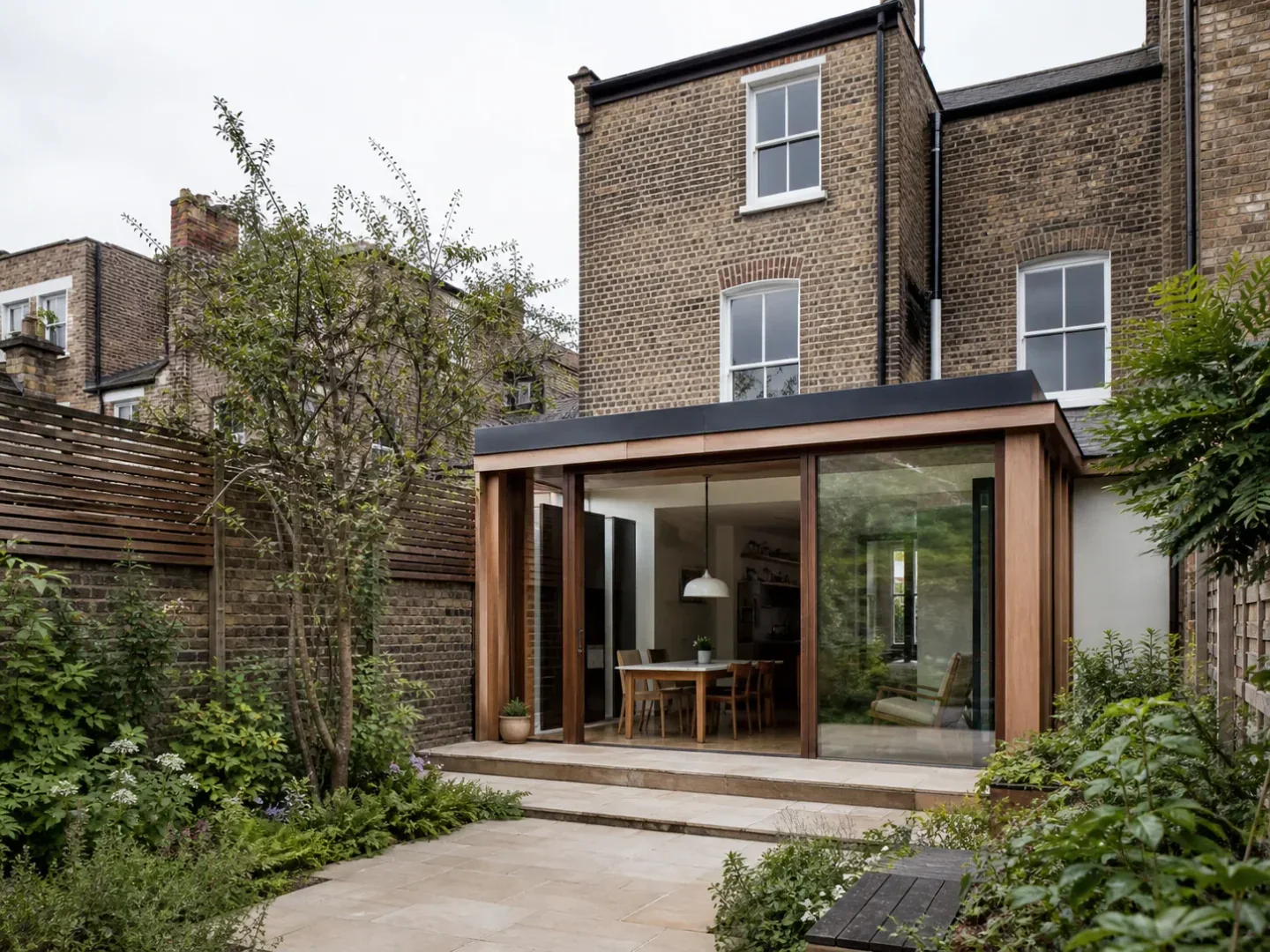 Timber and glass courtyard extension to an older brick townhouse