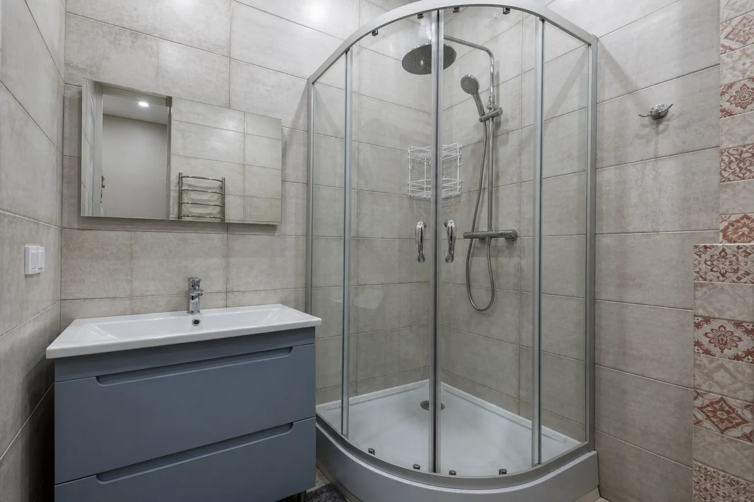 Compact gray bathroom with curved shower before an AI bathroom redesign