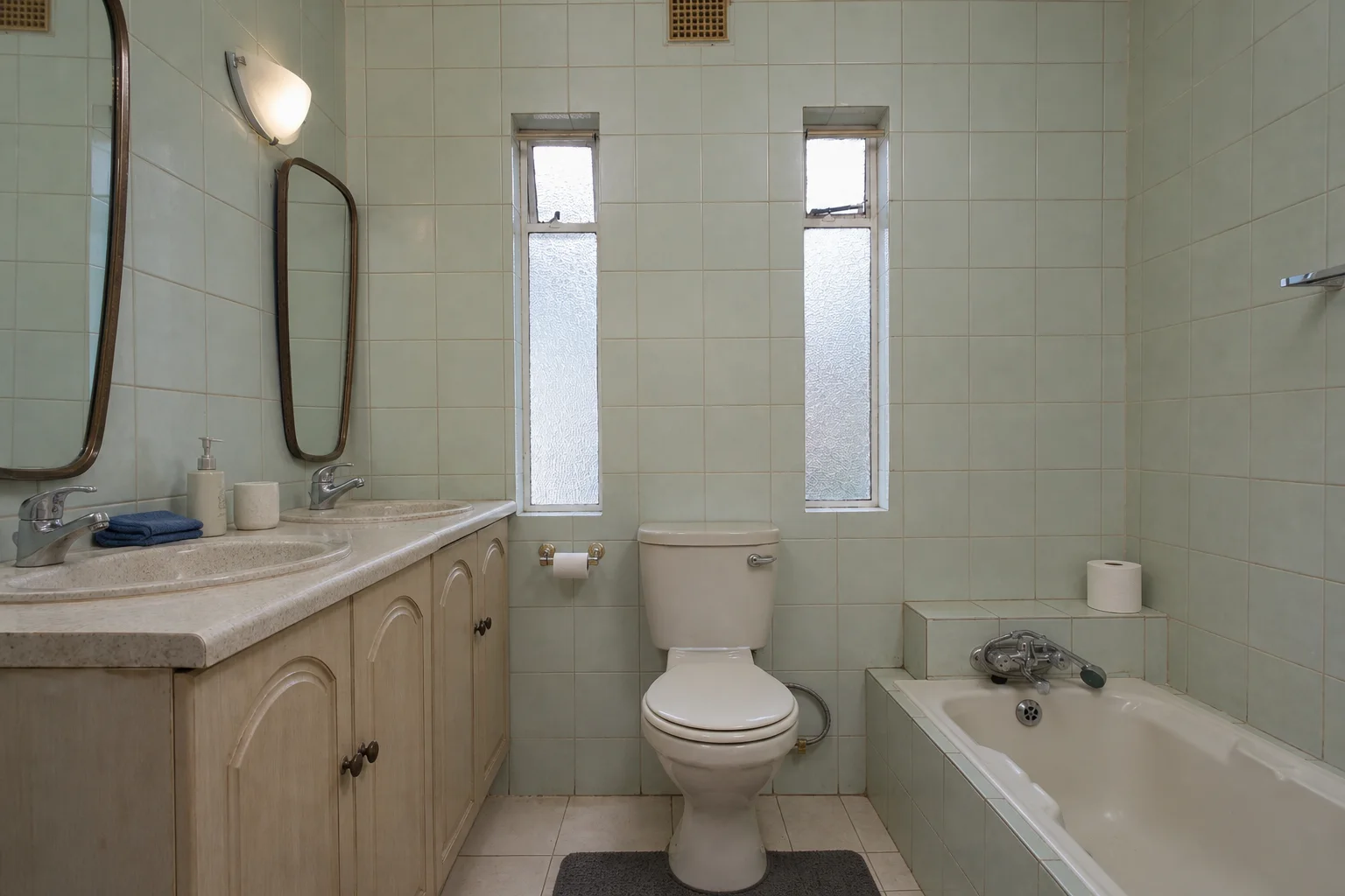 Dated mint tile bathroom before an AI bathroom design makeover