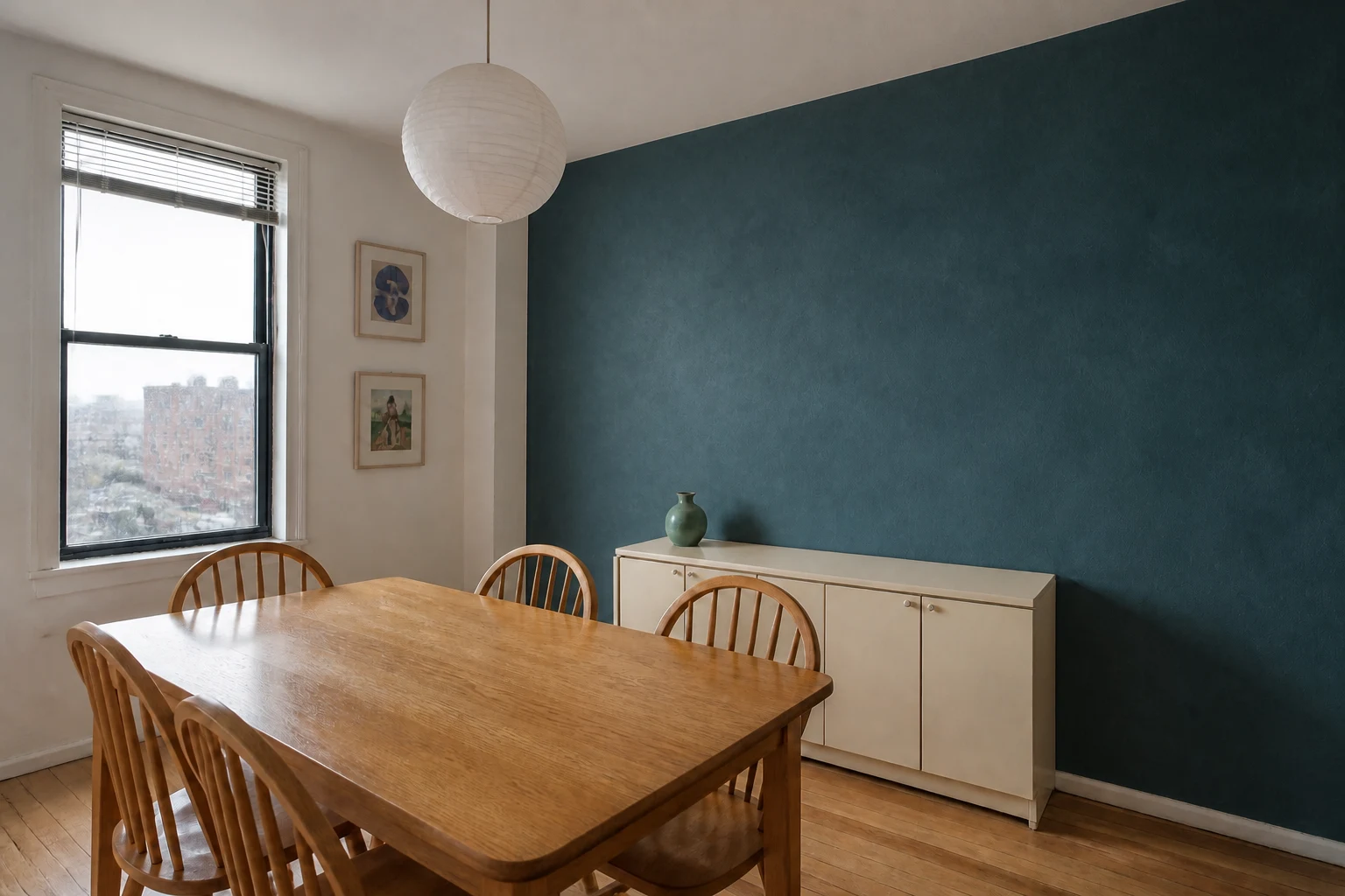 Same dining room after changing only the target wall to a deep petrol blue-green limewash finish