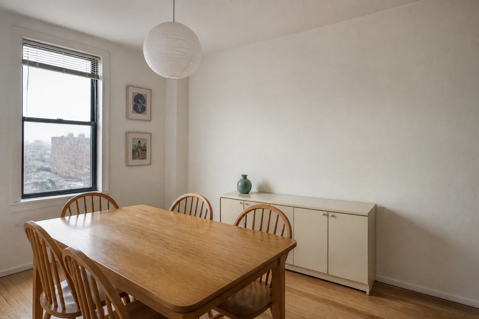Ordinary apartment dining room with a plain off-white wall before a focused AI material edit