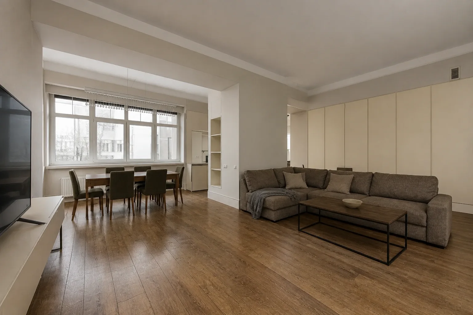 Open-plan family living and dining room before an AI redesign